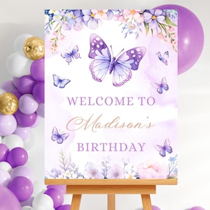 May include: Purple and white welcome sign with a watercolor butterfly design and the text "Welcome to Madison's Birthday".