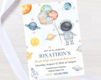 May include: A blue and white astronaut holding balloons shaped like planets. The planets are orange, yellow, blue, and brown. The text on the invitation reads "Join us to celebrate Jonathon's first trip around the sun. Saturday, August 12, 2024 at 1:00pm. Jonathon's Home 12345 Main St. RSVP: 123.456.7890"