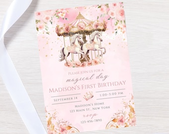 May include: Pink and gold first birthday invitation with a carousel and floral design. The text reads "Please join us for a magical day, Madison's First Birthday, September 14, 1:00-3:00 PM, Madison's Home, 123 Main St., New York, rsvp 123-456-7890".