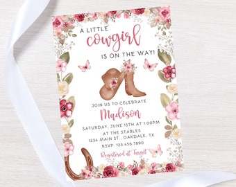 May include: A pink and white baby shower invitation with a floral border. The invitation says "A little cowgirl is on the way!" and includes the name "Madison".