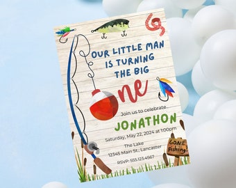 May include: A colorful invitation for a first birthday party with a fishing theme. The invitation features a fishing rod, a bobber, a fish, and a worm. The text on the invitation reads "Our little man is turning the big one. Join us to celebrate Jonathon. Saturday, May 22, 2024 at 1:00pm. The Lake 12345 Main St., Lancaster. RSVP: 555.123.4567. Gone Fishing!"