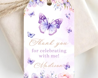 May include: A rectangular gift tag with a hole at the top and jute twine, featuring a watercolor design of purple butterflies and flowers. The text reads Thank you for celebrating with me! and the name Madison in a script font on a white background.