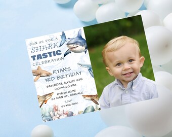 May include: A blue and white shark-themed birthday invitation with a photo of a young boy. The invitation says "Join us for a Shark Tastic Celebration" and includes the boy's name, age, and party details.