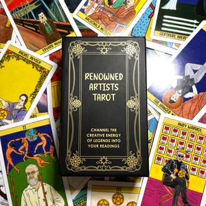 May include: A black tarot card box with gold lettering that reads "Renowned Artists Tarot." The box is surrounded by tarot cards featuring artwork and the names of famous artists like Andy Warhol and Henri Matisse. The cards have colorful illustrations.