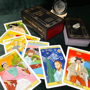 May include: A tarot card deck titled "Renowned Artists Tarot" with a black box and gold lettering. Several tarot cards are fanned out, featuring illustrations of famous artists like Frida Kahlo and Vincent van Gogh. A crystal ball and a quartz crystal are also present.
