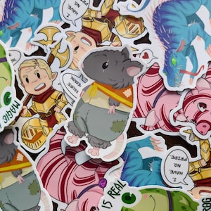 May include: A collection of colorful stickers featuring cartoon characters and fantasy creatures. The stickers include a gray mouse wearing a yellow scarf, a blue dragon, a pink pig, and a knight. Some stickers have text bubbles with phrases like "I have no pride."