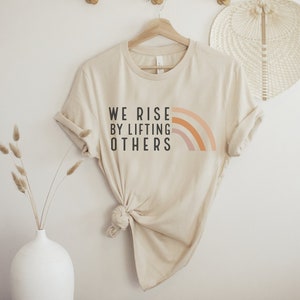 We Rise By Lifting Others Graphic Tee