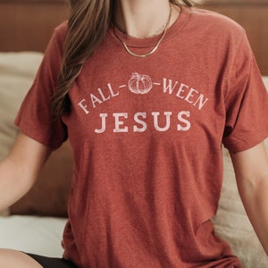 May include: A red t-shirt with the text "Fall-Ween Jesus" and a pumpkin graphic.
