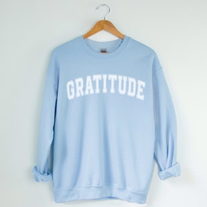 Gratitude Crewneck Sweatshirt, Cute Inspirational Varsity Vibe Sweatshirt Light Blue