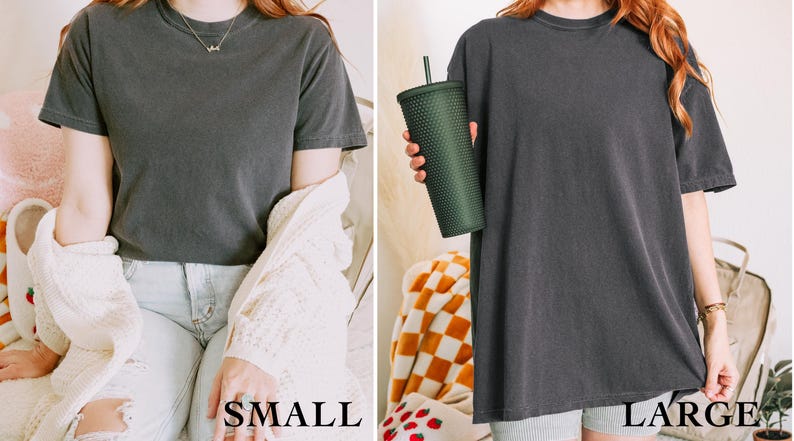 May include: Two women wearing the same charcoal gray t-shirt in different sizes. The woman on the left is wearing a small and the woman on the right is wearing a large. The text "SMALL" and "LARGE" is printed below each woman.