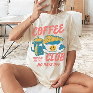 Coffee Club T-Shirt – Retro Coffee Lover Graphic Tee with Croissant And French Press – Cozy Aesthetic Gift Ivory