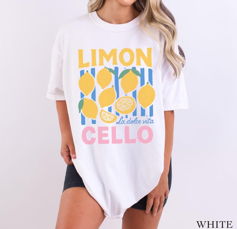 May include: White t-shirt with a lemon-themed graphic. The design features yellow lemons, blue and yellow stripes, and the words "LIMON CELLO" in yellow and pink, with "La dolce vita" in the middle.