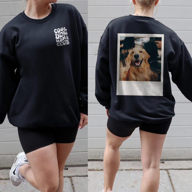 May include: Black sweatshirt with the text "Cool Dog Moms Club" printed on the front and a photo of a golden retriever in a Polaroid frame on the back.