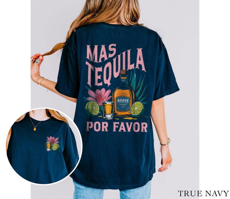 May include: A navy blue t-shirt with a graphic of a tequila bottle, shot glass, and flowers. The text "Mas Tequila Por Favor" is printed on the shirt.