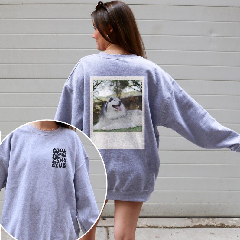 May include: Grey sweatshirt with a photo of a dog on the back and the text "Cool Dog Moms Club" on the front.