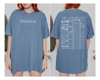May include: An oversized blue t-shirt with the text "bookworm" printed on the front and a library card design on the back.