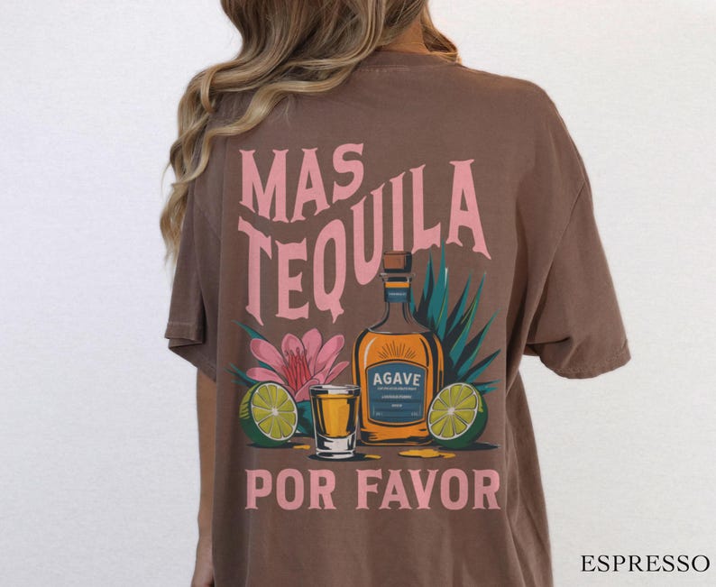 May include: Brown t-shirt with a pink graphic of a tequila bottle, limes, and a shot glass. The text on the shirt reads "Mas Tequila Por Favor".
