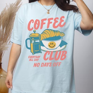 Coffee Club T-Shirt – Retro Coffee Lover Graphic Tee with Croissant And French Press – Cozy Aesthetic Gift Chambray