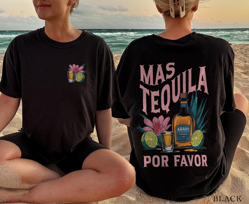 May include: Black t-shirt with a pink and white graphic design that says "Mas Tequila Por Favor" with a bottle of tequila, limes, and a shot glass.
