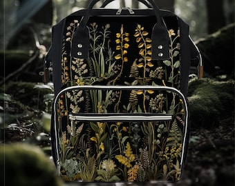 May include: A black backpack with a floral print featuring yellow, green, and brown botanical illustrations. The backpack has multiple pockets and a zipper closure.