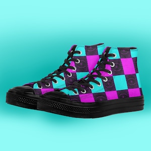 May include: High-top sneakers with a black and white checkered pattern in shades of pink and blue. The shoes have black laces and a black rubber sole.