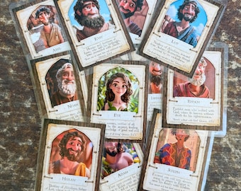 Puede incluir: Un conjunto de tarjetas ilustradas con figuras bíblicas como Adán, Eva y Noé. Cada tarjeta presenta un retrato, un nombre y una breve descripción. Las tarjetas están en fundas protectoras.