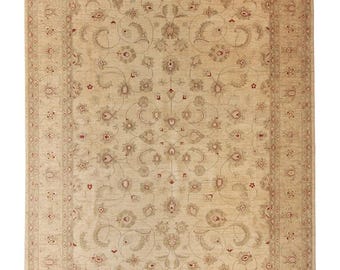 May include: Beige rectangular area rug with an intricate floral pattern. The rug features a central field with a repeating floral design in shades of beige, gray, and red. A border with a similar floral motif frames the central design. The rug is suitable for living rooms.