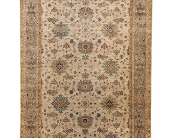 May include: Rectangular beige rug with an intricate floral pattern. The rug features a central field of beige with detailed floral and leaf motifs in shades of blue, brown, and green. A wide border frames the design.