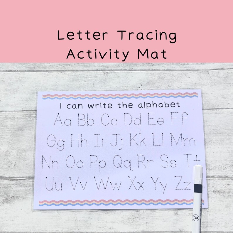 May include: A white laminated letter tracing activity mat with a blue and pink wavy border. The mat features the alphabet in uppercase and lowercase letters with dotted lines for tracing. The text "I can write the alphabet" is at the top of the mat.