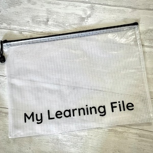 May include: A clear plastic mesh file folder with a black zipper and the text "My Learning File" printed in black.