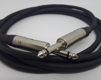 May include: A black guitar cable with two silver 1/4 inch mono plugs.