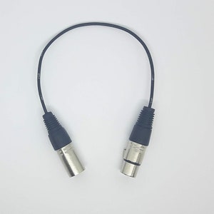 May include: A black XLR cable with two male connectors.