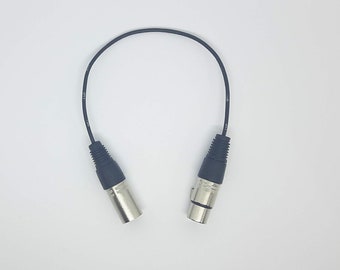 May include: A black XLR cable with two male connectors.