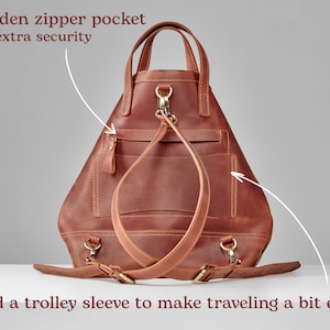 May include: A brown leather backpack with a hidden zipper pocket for extra security. The backpack has a trolley sleeve to make traveling easier.