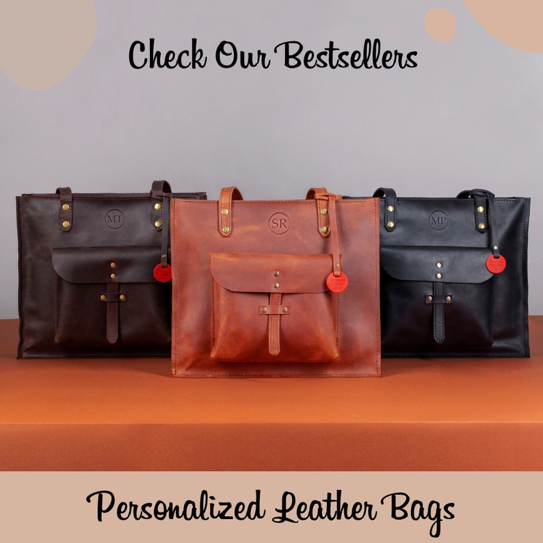 May include: Three personalized leather tote bags in brown, tan, and black. Each bag has a front pocket and a leather strap. The bags are arranged in a row on a brown surface. The text "Check Our Bestsellers" is at the top of the image and the text "Personalized Leather Bags" is at the bottom of the image.
