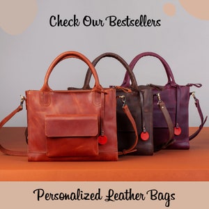 May include: Three leather tote bags in different colors: brown, dark brown, and purple. The bags have a top handle and a shoulder strap. The text "Check Our Bestsellers" is at the top of the image. The text "Personalized Leather Bags" is at the bottom of the image.