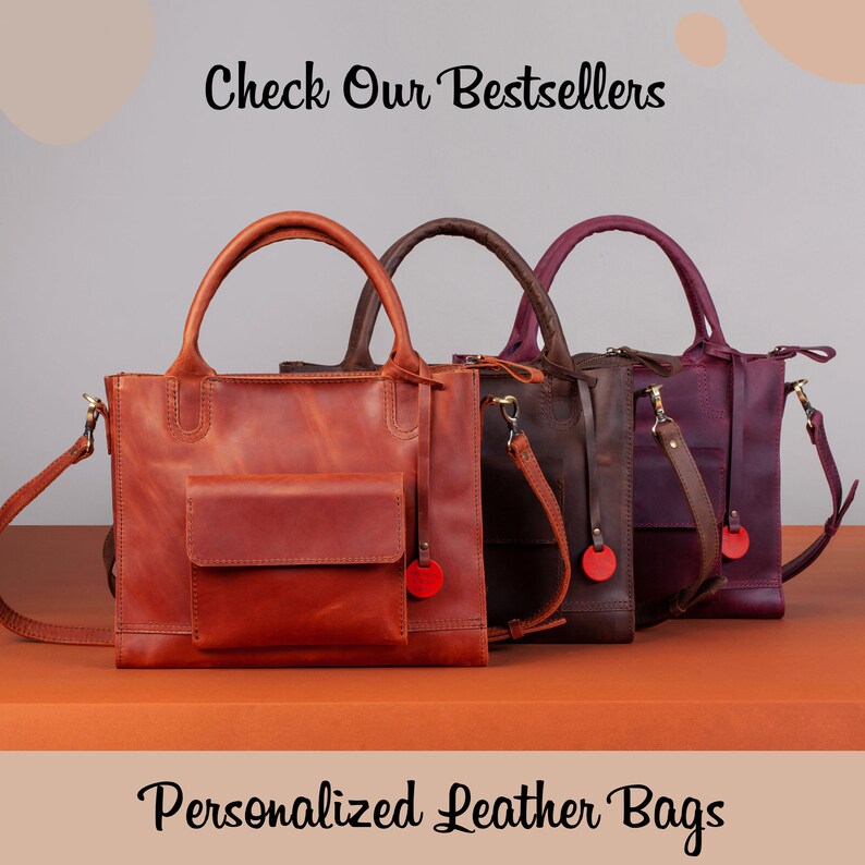 May include: Three leather tote bags in different colors: brown, dark brown, and purple. The bags have a top handle and a shoulder strap. The text "Check Our Bestsellers" is at the top of the image. The text "Personalized Leather Bags" is at the bottom of the image.
