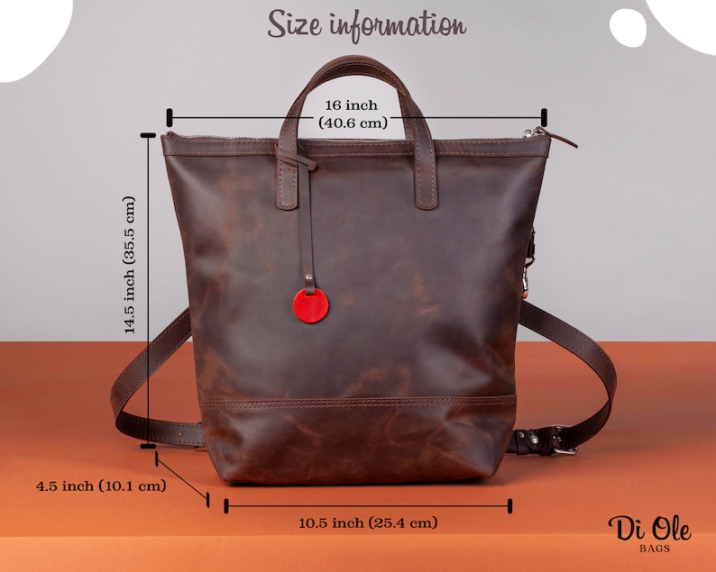 May include: Brown leather backpack with a top handle and adjustable straps. The backpack measures 14.5 inches tall, 10.5 inches wide, and 16 inches in height. The bag has a red circle logo on the front.