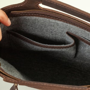 Brown leather briefcase for laptop. Inside there are several compartments and pockets lined with soft fabric. The ideal solution for carrying a laptop, documents and business accessories.