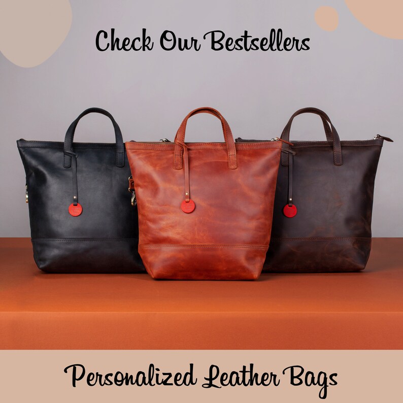 May include: Three leather tote bags in black, brown, and orange. The bags have a zipper closure and a small red circle on the front. The text "Check Our Bestsellers" is at the top of the image and "Personalized Leather Bags" is at the bottom.