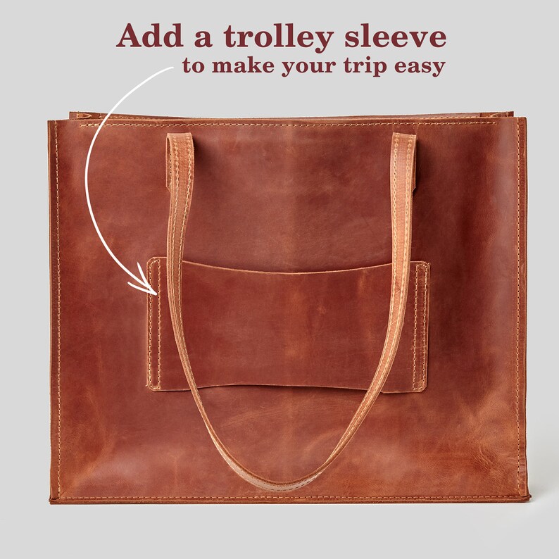 May include: A brown leather tote bag with two straps and a pocket on the front. The text "Add a trolley sleeve to make your trip easy" is written above the bag.