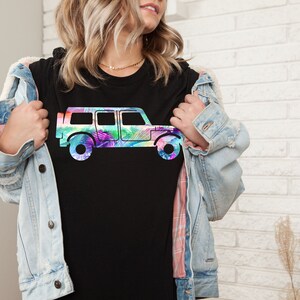 May include: A black t-shirt with a colorful graphic of a jeep. The jeep is outlined in black and filled with a rainbow of colors.