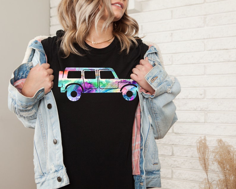 May include: A black t-shirt with a colorful graphic of a jeep. The jeep is outlined in black and filled with a rainbow of colors.