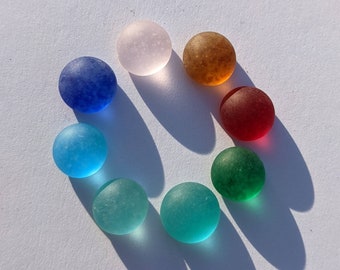 a selection of 8 flat backed, recycled and delicately frosted glass cabochons for jewellery or mosaic making. 9, 10 mm