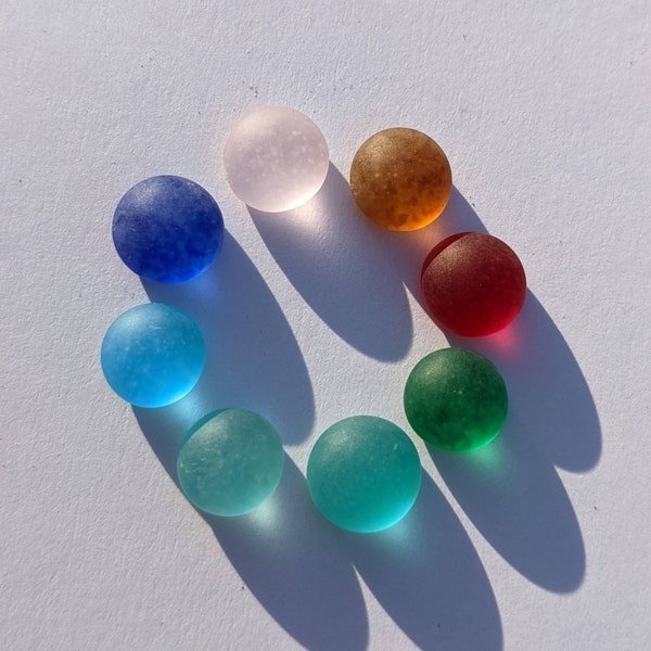 a selection of 8 flat backed, recycled and delicately frosted glass cabochons for jewellery or mosaic making. 9, 10 mm