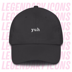 May include: A black baseball cap with the word "yuh" embroidered in white on the front.