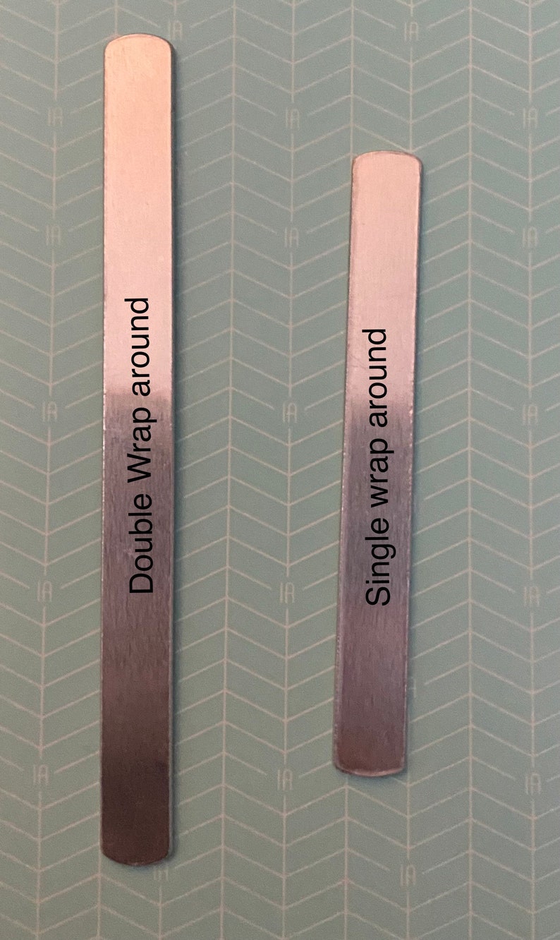 May include: Two silver metal strips with rounded edges. The strip on the left is labeled "Double Wrap around" and the strip on the right is labeled "Single wrap around".