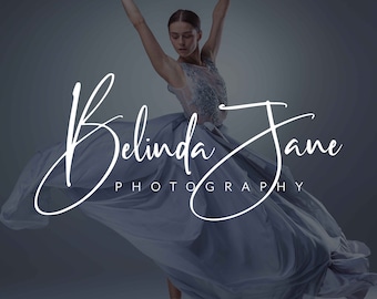 May include: A woman in a flowing light blue dress poses with her arms raised, creating a graceful silhouette. The text "Belinda Jane Photography" is written in a white cursive font below her.