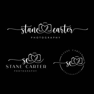 May include: A logo for a photography business called "Stane Carter Photography". The logo features a stylised camera with a heart in the middle. The logo is in white on a black background.