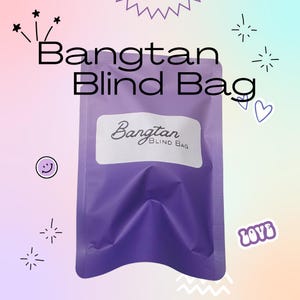 May include: A purple Bangtan Blind Bag with the text "Bangtan Blind Bag" in black. The bag has a white label with the word "Bangtan" in a script font. Decorative elements include stars, hearts, and a smiley face.